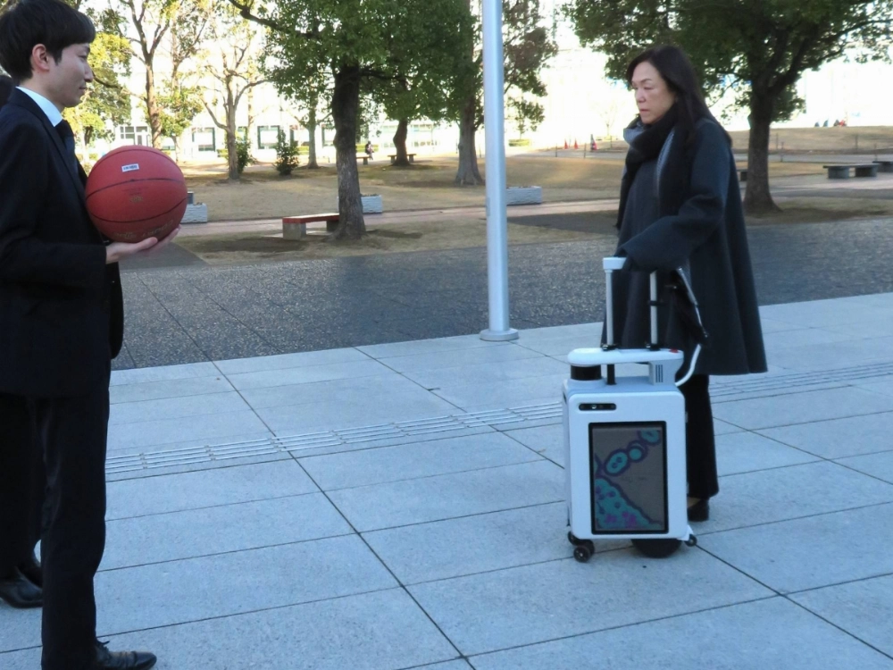 Chieko Asakawa, chief executive director of Miraikan, with an AI-powered suitcase designed to assist people with visual impairments, in Tokyo's Koto Ward on Jan. 22 Chieko Asakawa, chief executive director of Miraikan, with an AI-powered suitcase designed to assist people with visual impairments, in Tokyo's Koto Ward on Jan. 22