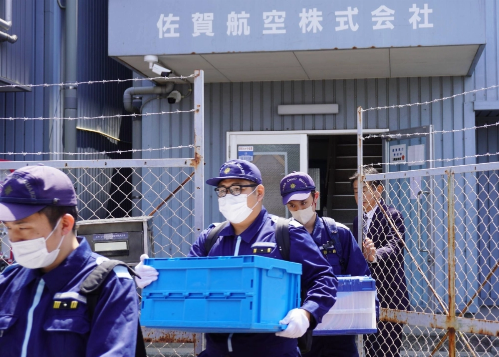 The Japan Coast Guard officers raid the office of SGC Saga Aviation in the city of Saga on Wednesday. The Japan Coast Guard officers raid the office of SGC Saga Aviation in the city of Saga on Wednesday.