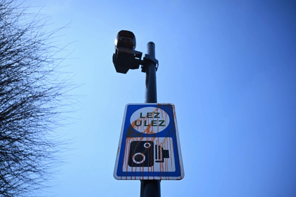 A vandalized sign indicating an ultralow emission zone in west London. A vandalized sign indicating an ultralow emission zone in west London.
