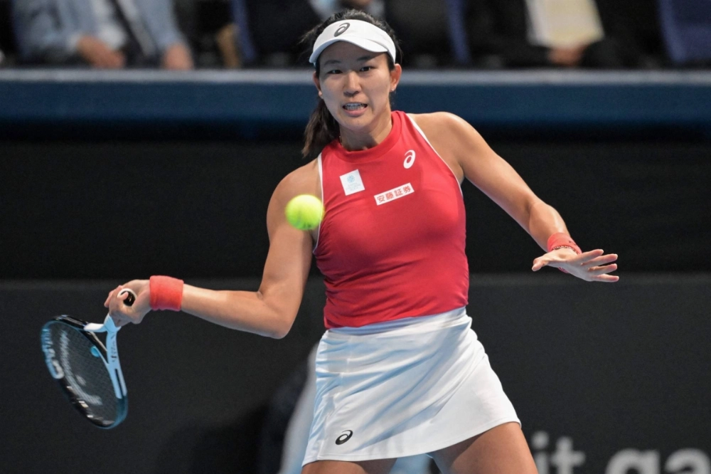 Japan's Moyuka Uchijima hits a return during a match against Romania's Anca Todoni as part of a Billie Jean King Cup qualifier in Tokyo on Saturday.  Japan's Moyuka Uchijima hits a return during a match against Romania's Anca Todoni as part of a Billie Jean King Cup qualifier in Tokyo on Saturday.
