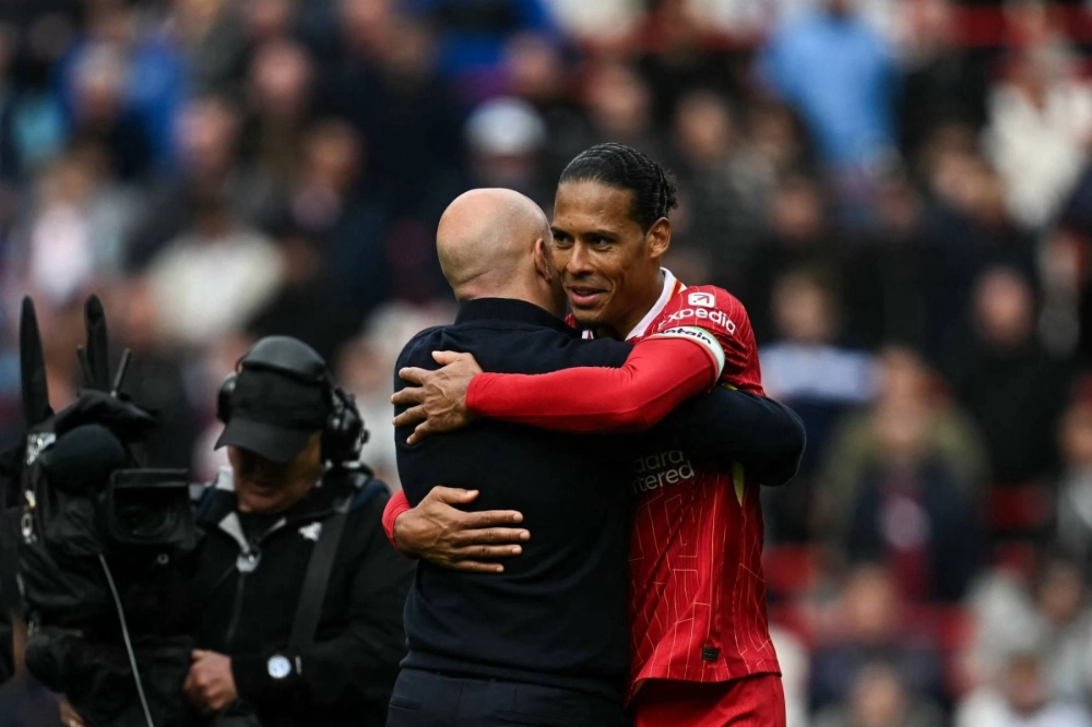 Liverpool manager Arne Slot (left) hugs defender Virgil van Dijk after their win over West Ham United in Liverpool, England, on Sunday. Liverpool manager Arne Slot (left) hugs defender Virgil van Dijk after their win over West Ham United in Liverpool, England, on Sunday.