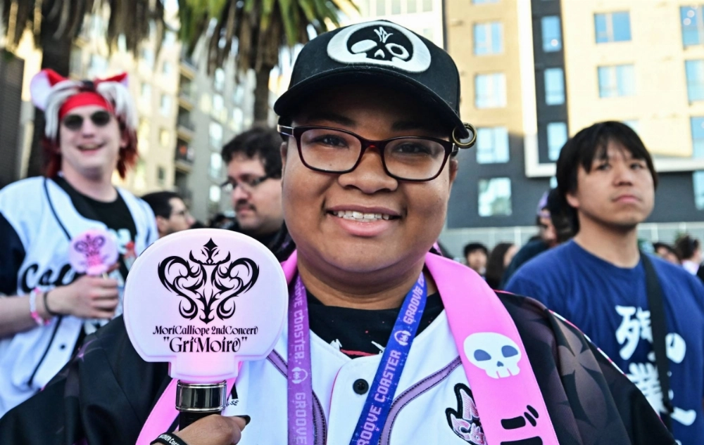 Mori Calliope fan Taylor Jones holds a penstick as fans await entry to the historic venue Hollywood Palladium for a sold-out concert by Virtual YouTuber Mori Calliope. Mori Calliope fan Taylor Jones holds a penstick as fans await entry to the historic venue Hollywood Palladium for a sold-out concert by Virtual YouTuber Mori Calliope.