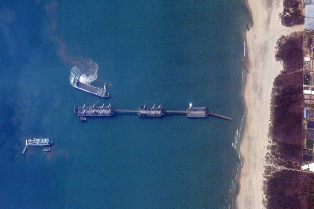 This satellite image taken on March 25 shows three Chinese barges connected via extendable bridges in waters off Zhanjiang, in southern China's Guangdong province. Experts say the new barges could be used to land heavy equipment and thousands of personnel in a possible invasion of Taiwan. This satellite image taken on March 25 shows three Chinese barges connected via extendable bridges in waters off Zhanjiang, in southern China's Guangdong province. Experts say the new barges could be used to land heavy equipment and thousands of personnel in a possible invasion of Taiwan.