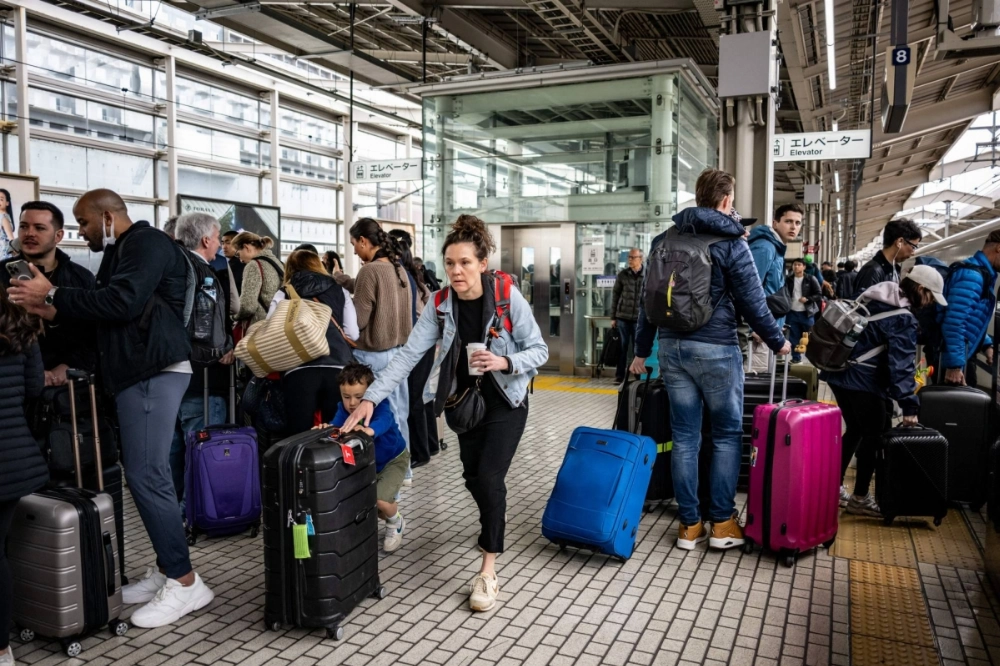 Foreign tourists gather on a platform at Kyoto Station on Wednesday. Foreign tourists gather on a platform at Kyoto Station on Wednesday.