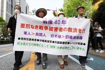 Protesters march in Tokyo's upscale Ginza district Saturday, demanding relief for those who suffered during World War II. Protesters march in Tokyo's upscale Ginza district Saturday, demanding relief for those who suffered during World War II.