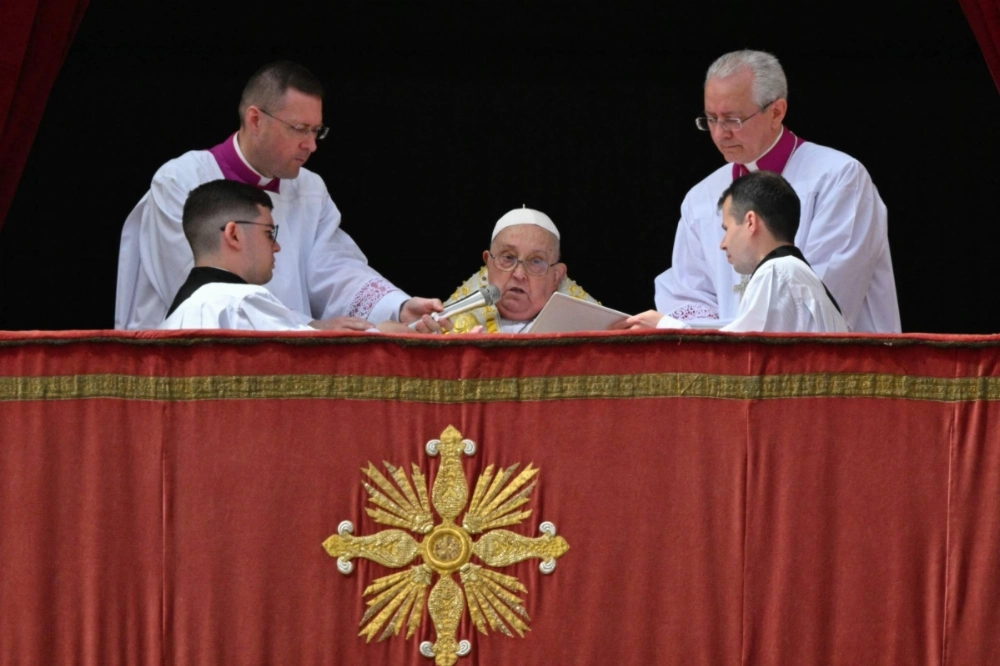 Pope Francis addresses the crowd from the main balcony of St. Peter's basilica during the Urbi et Orbi message as part of Easter celebrations on Sunday.  Pope Francis addresses the crowd from the main balcony of St. Peter's basilica during the Urbi et Orbi message as part of Easter celebrations on Sunday.