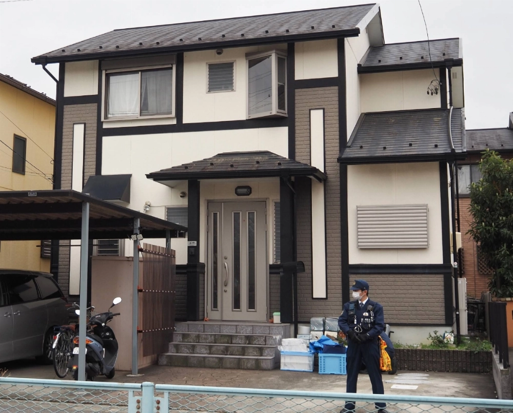 A police officer stands guard on April 1 at the home of Masaki Eguchi in Ichinomiya, Aichi Prefecture, where the body of Waka Kato had been found in a closet. A police officer stands guard on April 1 at the home of Masaki Eguchi in Ichinomiya, Aichi Prefecture, where the body of Waka Kato had been found in a closet.