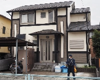 A police officer stands guard on April 1 at the home of Masaki Eguchi in Ichinomiya, Aichi Prefecture, where the body of Waka Kato had been found in a closet. | Jiji