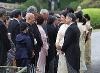 Emperor Naruhito and Empress Masako host a garden party at the Akasaka Imperial Gardens in Tokyo's Minato Ward on Tuesday. | Jiji