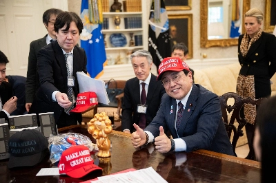 Japan’s chief tariff negotiator, Ryosei Akazawa, poses with a "Make America Great Again" cap at the White House in Washington on April 16. Japan’s chief tariff negotiator, Ryosei Akazawa, poses with a "Make America Great Again" cap at the White House in Washington on April 16.