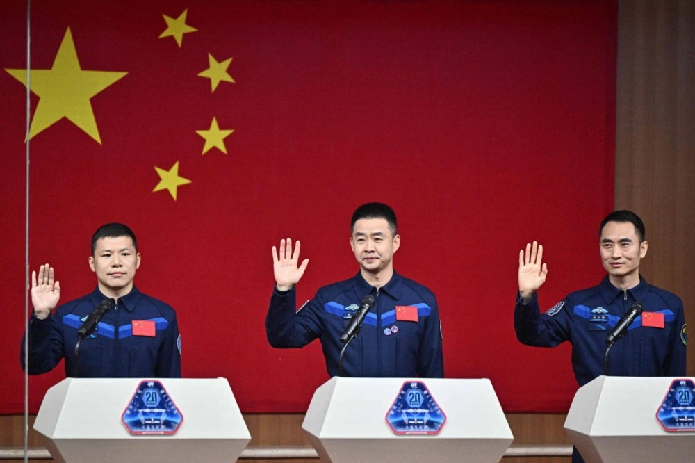 Astronauts for China's Shenzhou-20 space mission Wang Jie (left), Chen Dong (center) and Chen Zhongrui wave during a news conference a day before the launch of the mission, at the Jiuquan Satellite Launch Center in the Gobi desert, in northwest China, on Wednesday. Astronauts for China's Shenzhou-20 space mission Wang Jie (left), Chen Dong (center) and Chen Zhongrui wave during a news conference a day before the launch of the mission, at the Jiuquan Satellite Launch Center in the Gobi desert, in northwest China, on Wednesday.