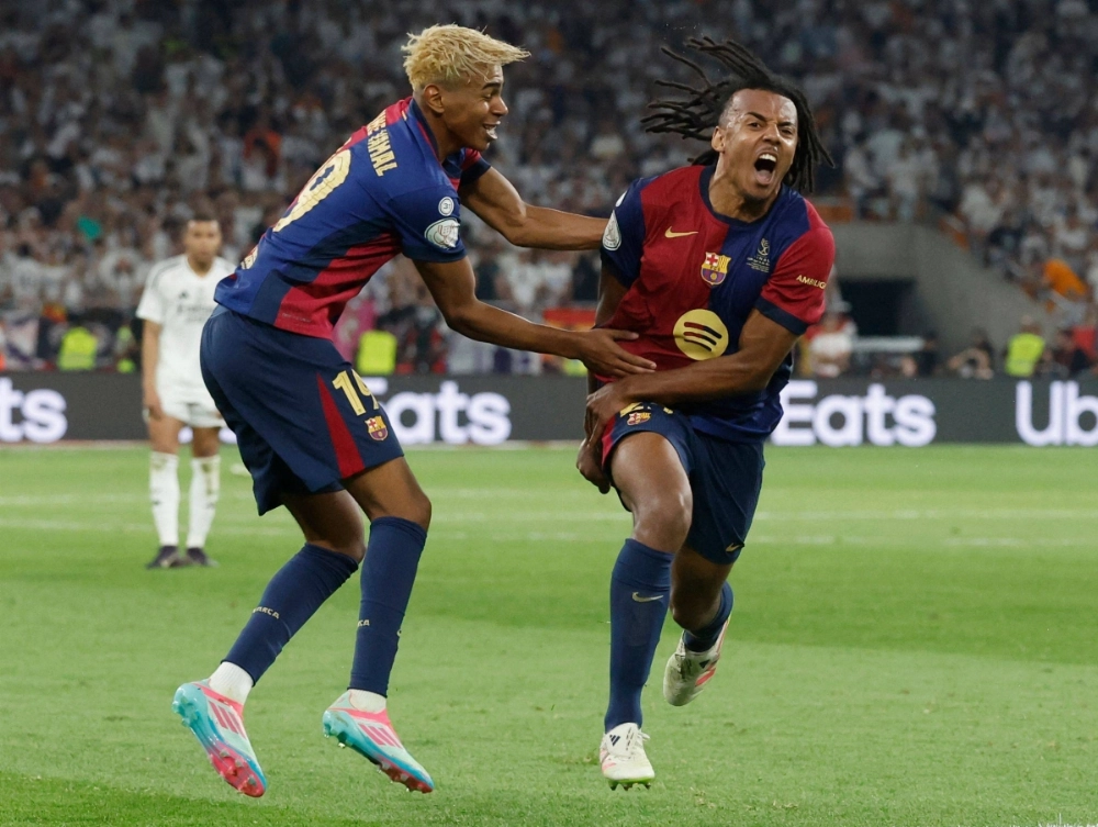 Barcelona defender Jules Kounde (right) celebrates alongside forward Lamine Yamal during the Copa del Rey final in Seville, Spain, on Saturday.  Barcelona defender Jules Kounde (right) celebrates alongside forward Lamine Yamal during the Copa del Rey final in Seville, Spain, on Saturday.