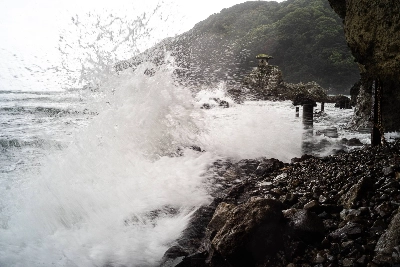 A small shrine perched atop rocks braves the waves hitting the shoreline during a storm in Shimoda, Shizuoka Prefecture. The area is under threat of a possible 31-meter-high tsunami if an earthquake strikes the nearby Nankai Trough.  A small shrine perched atop rocks braves the waves hitting the shoreline during a storm in Shimoda, Shizuoka Prefecture. The area is under threat of a possible 31-meter-high tsunami if an earthquake strikes the nearby Nankai Trough.