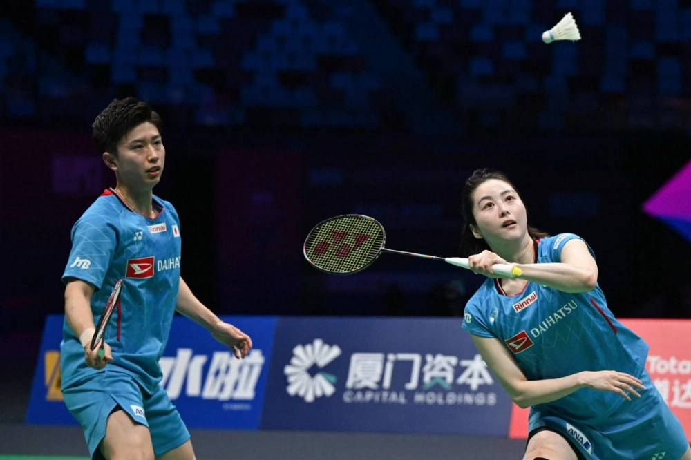 Yuichi Shimogami (left) and Sayaka Hobara hit a return to France's Gregoire Deschamp and Elsa Jacob during their mixed doubles match in the Sudirman Cup in Xiamen, China, on Tuesday. Yuichi Shimogami (left) and Sayaka Hobara hit a return to France's Gregoire Deschamp and Elsa Jacob during their mixed doubles match in the Sudirman Cup in Xiamen, China, on Tuesday.