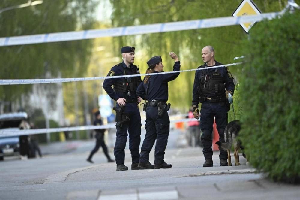 Police officers cordon off the scene after several people were killed in a shooting at Vaksala Square in central Uppsala, Sweden on Tuesday. Police officers cordon off the scene after several people were killed in a shooting at Vaksala Square in central Uppsala, Sweden on Tuesday.