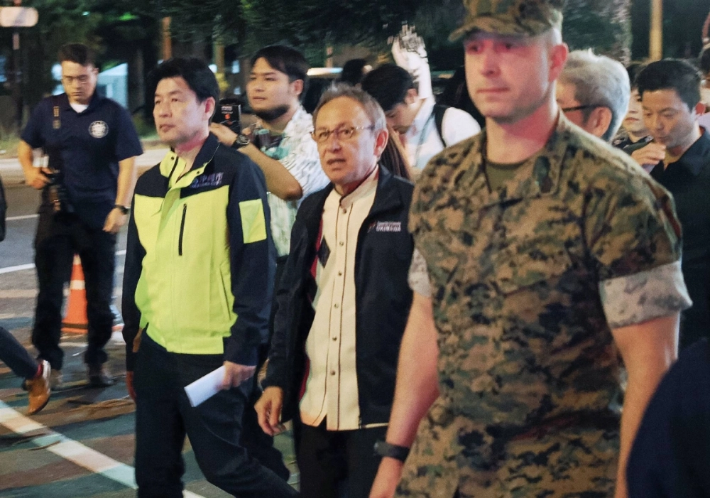 Okinawa Gov. Denny Tamaki (center) takes part in a joint patrol involving the U.S. military and the Okinawa Prefectural Police in the city of Okinawa on April 18. Okinawa Gov. Denny Tamaki (center) takes part in a joint patrol involving the U.S. military and the Okinawa Prefectural Police in the city of Okinawa on April 18.