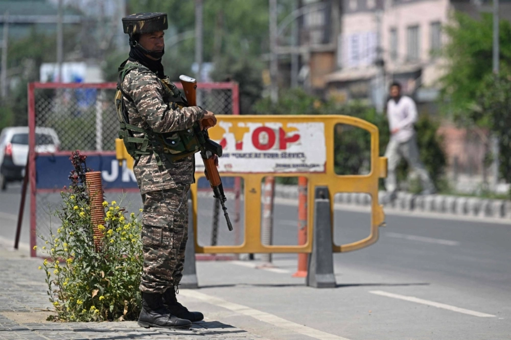 An Indian paramilitary trooper stands guard along a street in Srinagar on Wednesday. An Indian paramilitary trooper stands guard along a street in Srinagar on Wednesday.
