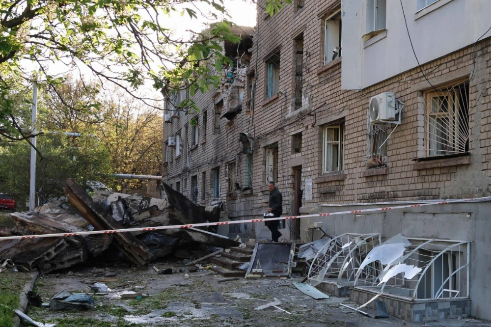 A local resident takes his belongings out of a damaged residential building after a drone attack in Zaporizhzhia, Ukraine, on Friday. A local resident takes his belongings out of a damaged residential building after a drone attack in Zaporizhzhia, Ukraine, on Friday.