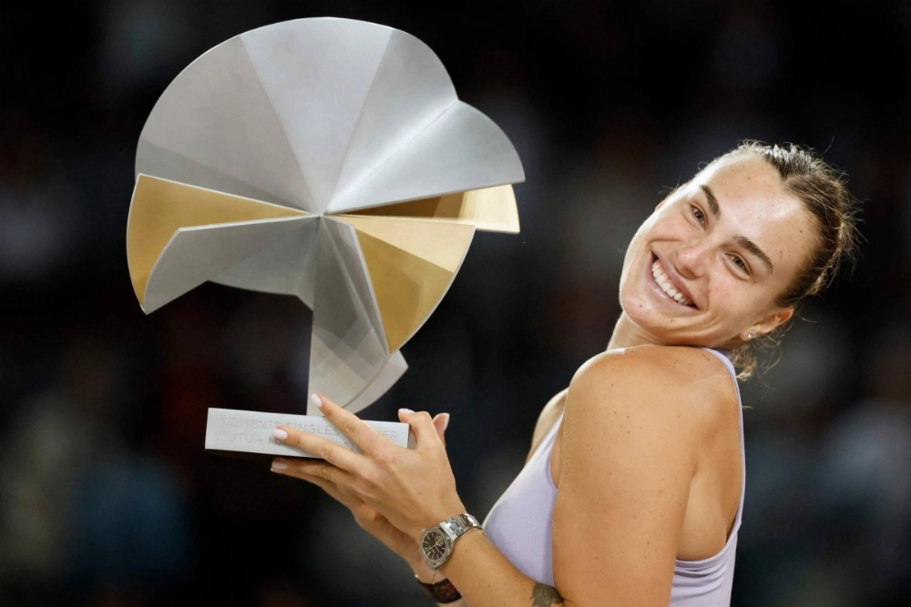 Aryna Sabalenka poses with the winner's trophy after beating Coco Gauff in the final of the Madrid Open.  Aryna Sabalenka poses with the winner's trophy after beating Coco Gauff in the final of the Madrid Open.