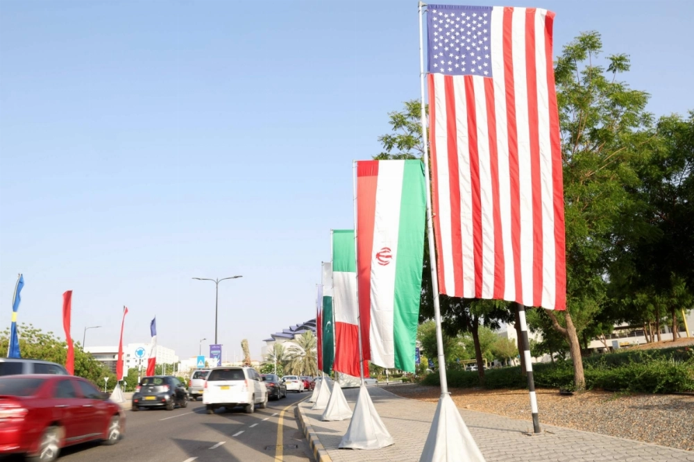 The flags of the U.S. and Iran hang on the road leading to the Muscat International Book fair in Oman on April 25. The flags of the U.S. and Iran hang on the road leading to the Muscat International Book fair in Oman on April 25.