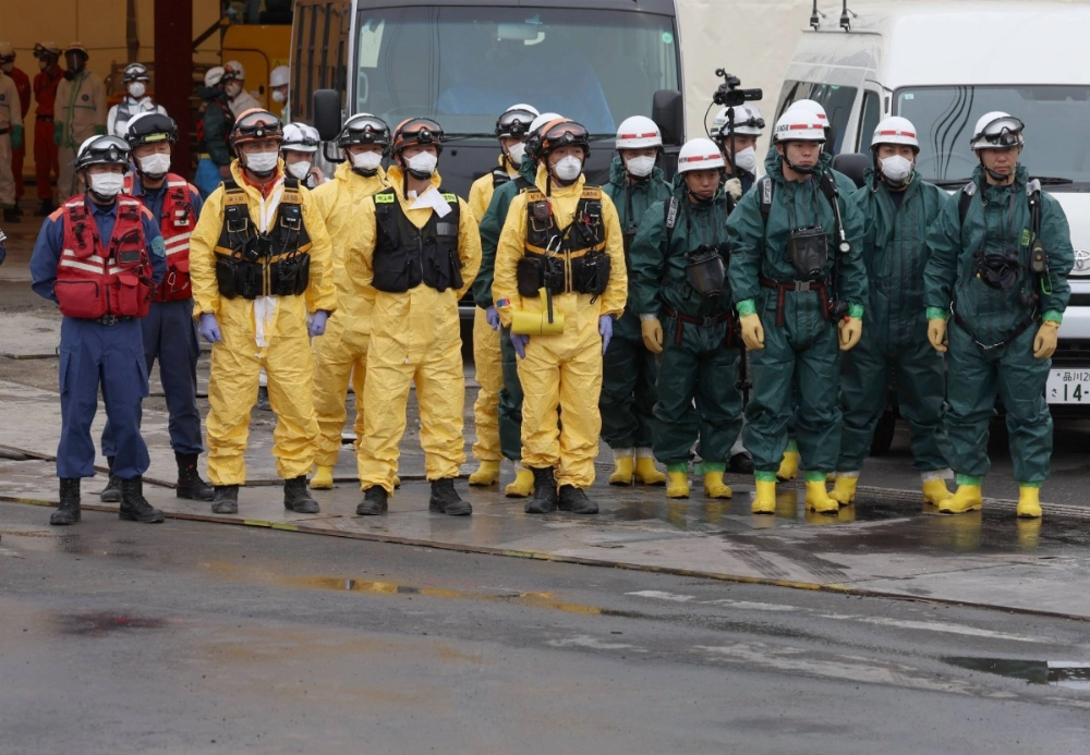 Firefighters see off a vehicle carrying a body recovered from a sinkhole in Yashio, Saitama Prefecture, on May 2. Firefighters see off a vehicle carrying a body recovered from a sinkhole in Yashio, Saitama Prefecture, on May 2.