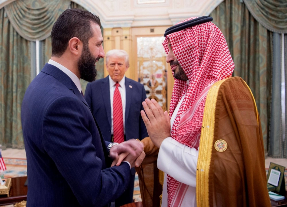 Saudi Crown Prince Mohammed bin Salman (right) greets interim Syrian President Ahmad al-Sharaa (left) as U.S. President Donald Trump looks on in Riyadh on Wednesday. Saudi Crown Prince Mohammed bin Salman (right) greets interim Syrian President Ahmad al-Sharaa (left) as U.S. President Donald Trump looks on in Riyadh on Wednesday.