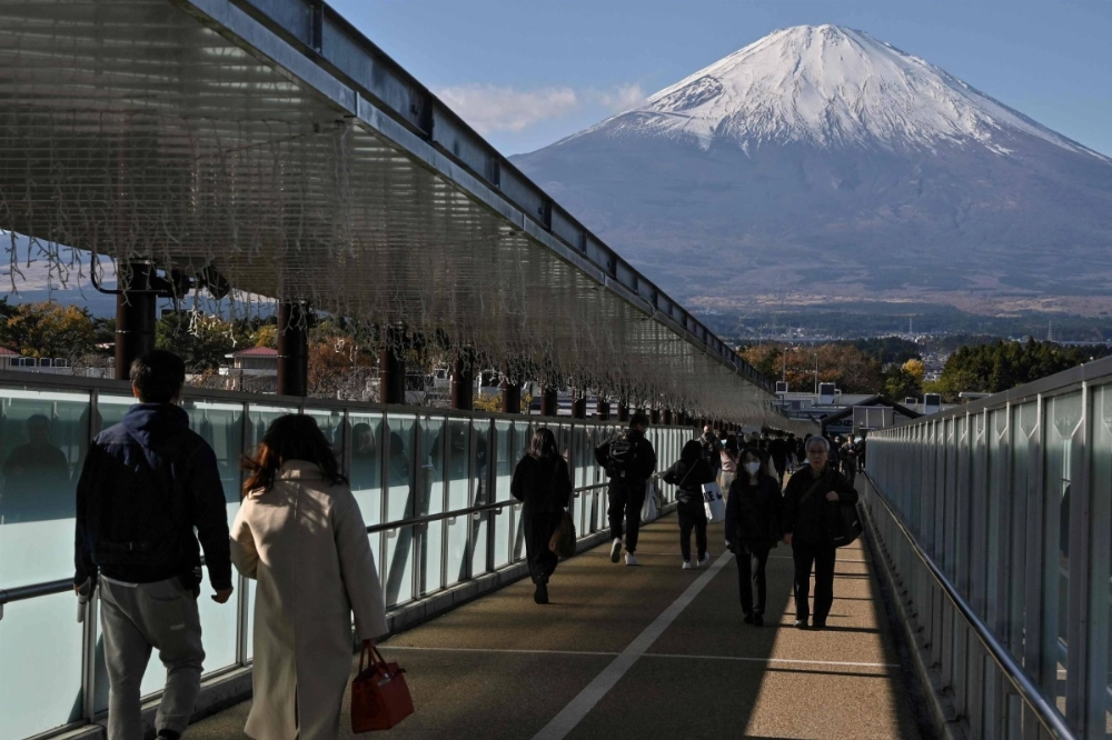 Mount Fuji fills the skyline above a bridge connecting stores at a popular outlet shopping center in the city of Gotemba, Shizuoka Prefecture, in November 2024. Mount Fuji fills the skyline above a bridge connecting stores at a popular outlet shopping center in the city of Gotemba, Shizuoka Prefecture, in November 2024.