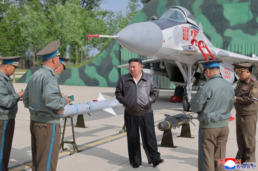 North Korean leader Kim Jong Un stands beside a MiG-29 aircraft and air-launched weaponry on display during anti-air combat and air raid drills at an undisclosed location in the country on Thursday.  North Korean leader Kim Jong Un stands beside a MiG-29 aircraft and air-launched weaponry on display during anti-air combat and air raid drills at an undisclosed location in the country on Thursday.