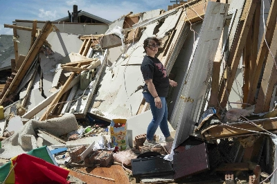 A woman inspects damage from a tornado in London, Kentucky, on Saturday. More than 25 people have died after severe storms swept through the southern U.S. states of Missouri and Kentucky, officials and local media reports said. A woman inspects damage from a tornado in London, Kentucky, on Saturday. More than 25 people have died after severe storms swept through the southern U.S. states of Missouri and Kentucky, officials and local media reports said.