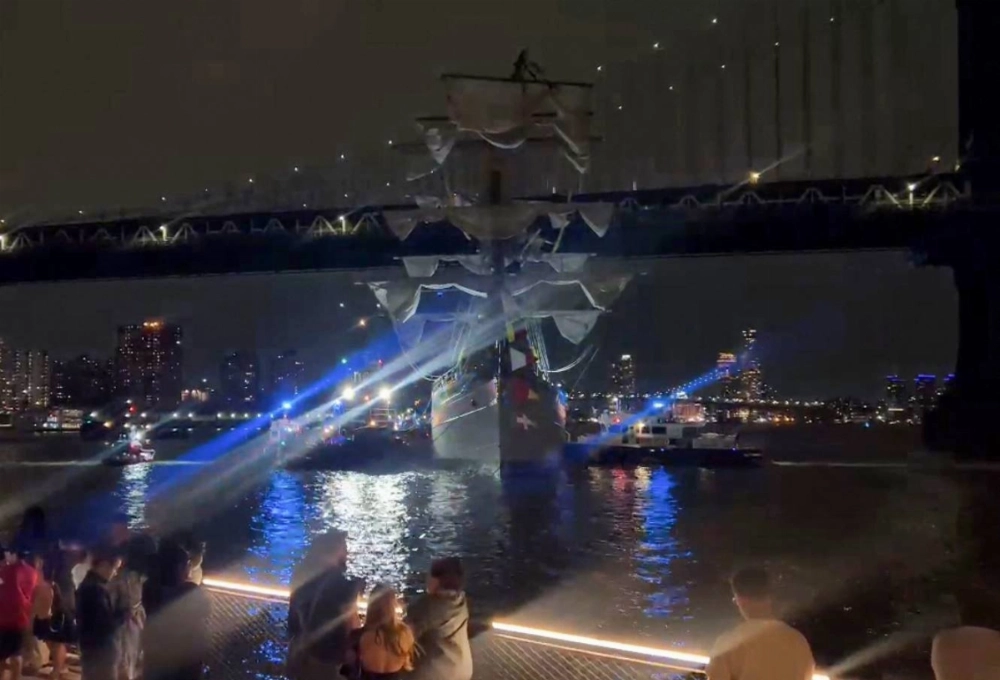 A Mexican Navy training ship is seen near the Manhattan Bridge after it slammed into the nearby Brooklyn Bridge in New York on Saturday. A Mexican Navy training ship is seen near the Manhattan Bridge after it slammed into the nearby Brooklyn Bridge in New York on Saturday.