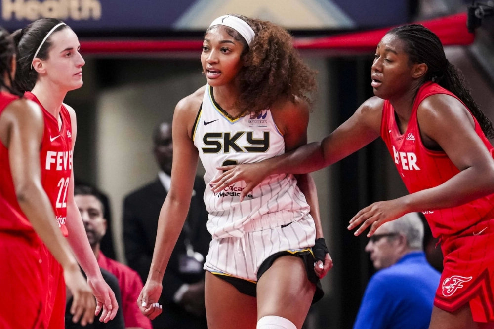 Sky forward Angel Reese (center) reacts after receiving a flagrant foul from Fever guard Caitlin Clark (left) during their game in Indianapolis on Saturday. Sky forward Angel Reese (center) reacts after receiving a flagrant foul from Fever guard Caitlin Clark (left) during their game in Indianapolis on Saturday.