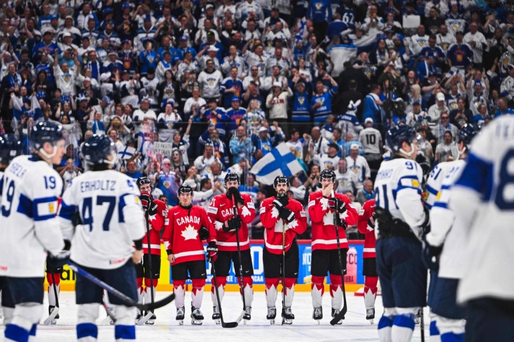 Canada's players react to their defeat at the end of an IIHF Men's Ice Hockey World Championship match against Finland in Stockholm on Monday.  Canada's players react to their defeat at the end of an IIHF Men's Ice Hockey World Championship match against Finland in Stockholm on Monday.