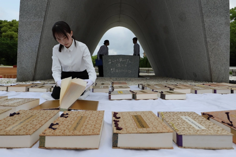 A city government official airs out the register of people who died as a result of the U.S. atomic bombing of Hiroshima on Thursday for its upkeep in the Hiroshima Peace Memorial Park A city government official airs out the register of people who died as a result of the U.S. atomic bombing of Hiroshima on Thursday for its upkeep in the Hiroshima Peace Memorial Park