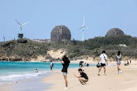 The Maanshan Nuclear Power Plant, which was shuttered last week, is seen from a beach in Pingtung, southern Taiwan, on April 29. | AFP-JIJI