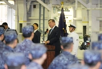 Prime Minister Shigeru Ishiba speaks with members of the Maritime Self-Defense Force in Kyoto Prefecture on Sunday. | Pool / via Jiji