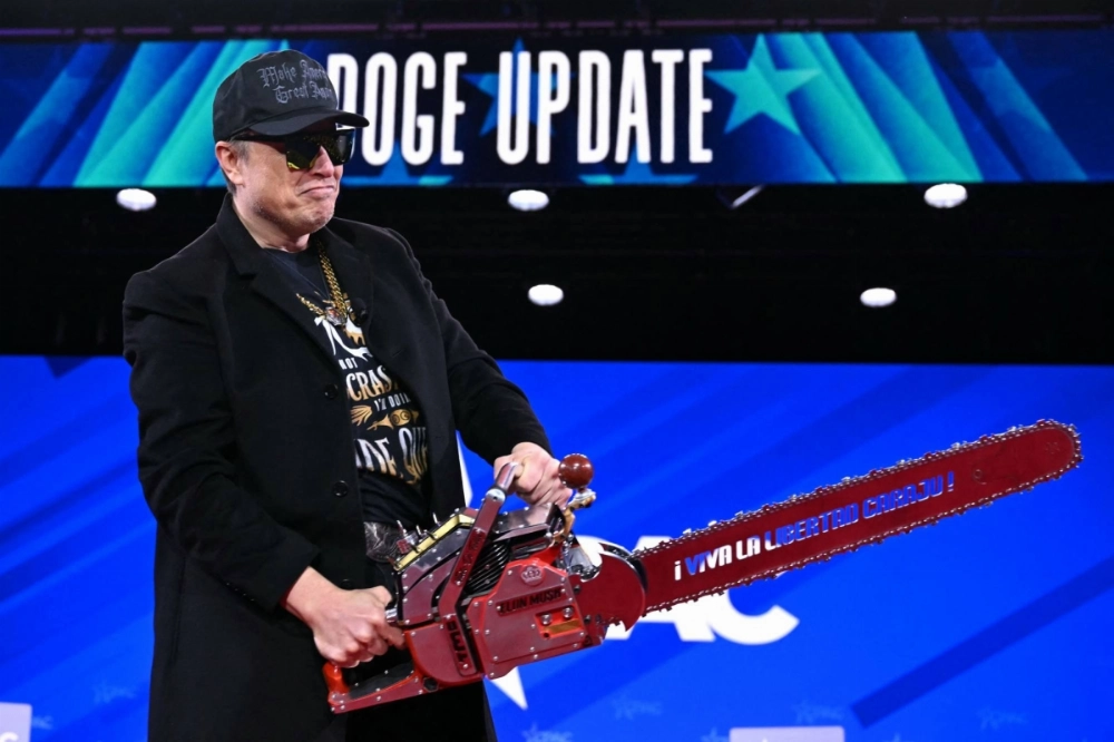 Elon Musk holds a chainsaw featuring a Spanish slogan that translates as  "Long live freedom, damn it" during the annual Conservative Political Action Conference (CPAC) at the Gaylord National Resort & Convention Center at National Harbor in Oxon Hill, Maryland, on Feb. 20. Elon Musk holds a chainsaw featuring a Spanish slogan that translates as  "Long live freedom, damn it" during the annual Conservative Political Action Conference (CPAC) at the Gaylord National Resort & Convention Center at National Harbor in Oxon Hill, Maryland, on Feb. 20.