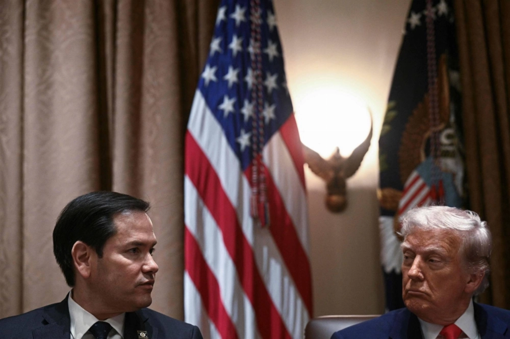 U.S. President Donald Trump (right) listens to Secretary of State Marco Rubio at the White House in Washington on April 10.  U.S. President Donald Trump (right) listens to Secretary of State Marco Rubio at the White House in Washington on April 10.