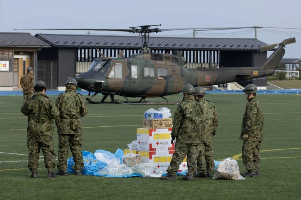 Members of the Japan Self-Defense Forces prepare to load boxes of medical relief supplies onto a helicopter in Wajima, Ishikawa Prefecture, in September last year. Members of the Japan Self-Defense Forces prepare to load boxes of medical relief supplies onto a helicopter in Wajima, Ishikawa Prefecture, in September last year.