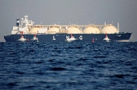 A tanker transporting LNG is tugged toward a thermal power station in Futtsu, Chiba Prefecture. After the end of World War II, coal and petroleum imports were Japan's main sources of energy. But that would change in 1969, when the first ship transported LNG from Alaska to Japan. | Reuters