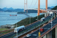 Tanker trucks carrying LNG from a terminal across the Xihoumen Bridge in Zhoushan, China. While Japan still has the largest number of LNG import terminal capacity and regasification facilities, China has many under construction and could overtake Japan in both categories by 2030. | Reuters