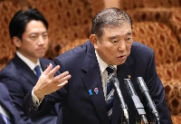 Prime Minister Shigeru Ishiba speaks at an Upper House Budget Committee meeting on Monday as agriculture minister Shinjiro Koizumi looks on. | Jiji