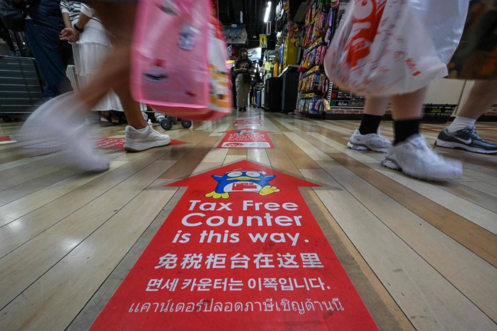 Arrows lead to the tax-free counter at a branch of discount retailer Don Quijote in Tokyo's Shibuya Ward. Arrows lead to the tax-free counter at a branch of discount retailer Don Quijote in Tokyo's Shibuya Ward.