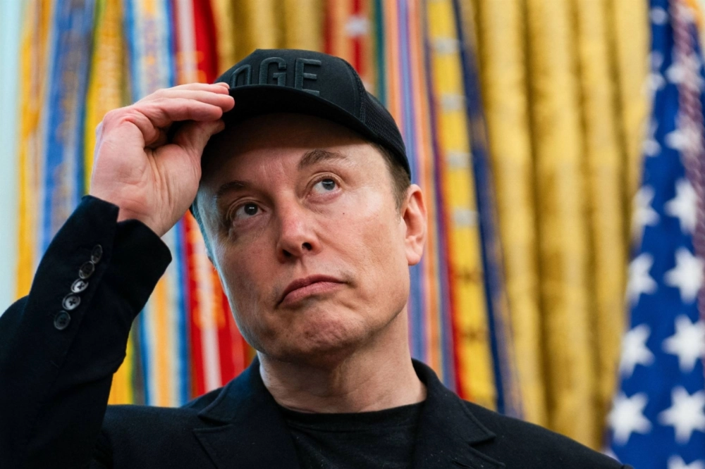 Elon Musk looks on during a news conference with U.S. President Donald Trump in the Oval Office of the White House in Washington on Saturday. Musk has dubbed Trump's sweeping tax and spending bill as a "disgusting abomination."  Elon Musk looks on during a news conference with U.S. President Donald Trump in the Oval Office of the White House in Washington on Saturday. Musk has dubbed Trump's sweeping tax and spending bill as a "disgusting abomination."