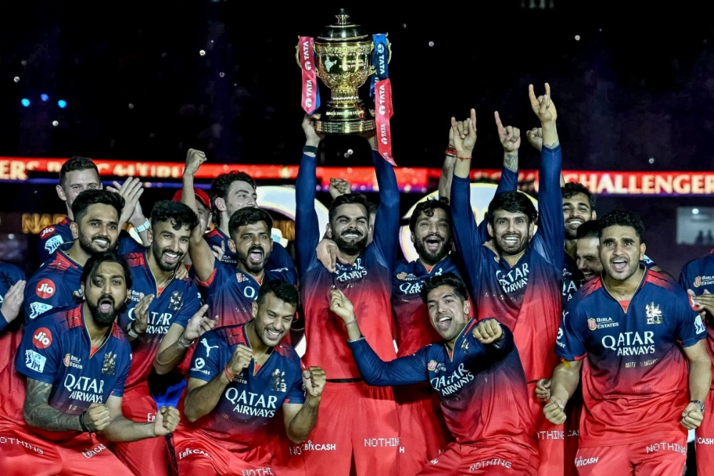 Royal Challengers Bengaluru's Virat Kohli (center), along with his teammates, celebrates with the trophy after winning the Indian Premier League (IPL) Twenty20 final cricket match against Punjab Kings at the Narendra Modi Stadium in Ahmedabad on Tuesday. Royal Challengers Bengaluru's Virat Kohli (center), along with his teammates, celebrates with the trophy after winning the Indian Premier League (IPL) Twenty20 final cricket match against Punjab Kings at the Narendra Modi Stadium in Ahmedabad on Tuesday.