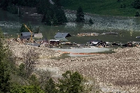 Debris and the rest of the village of Blatten, now submerged by the obstructed river Lonza, after the huge Birch Glacier collapsed and a massive landslide in the Swiss Alps on Saturday. | AFP-JIJI