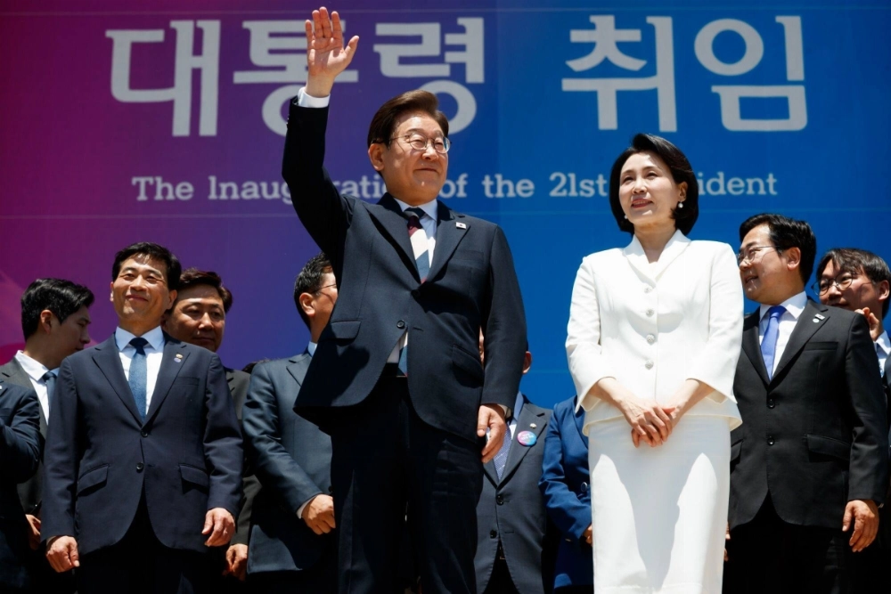 South Korean President Lee Jae-myung waves with his his wife, Kim Hye-gyeong, following his inauguration ceremony at the National Assembly in Seoul on Wednesday. South Korean President Lee Jae-myung waves with his his wife, Kim Hye-gyeong, following his inauguration ceremony at the National Assembly in Seoul on Wednesday.