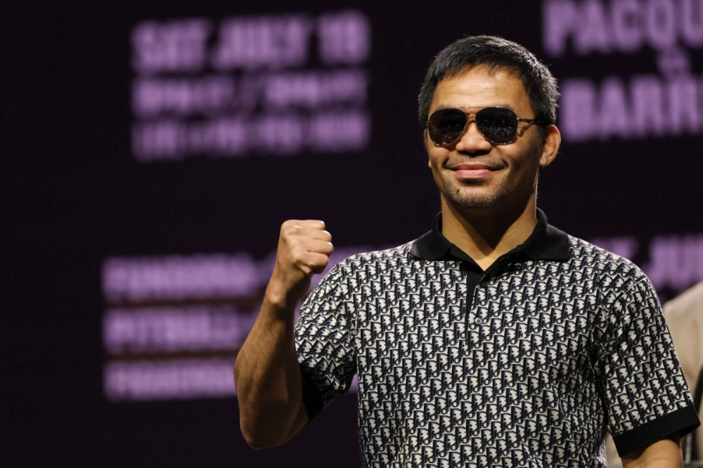 Manny Pacquiao raises his fist during a press conference ahead of his July 19 WBC welterweight title fight against Mexican-US boxer Mario Barrios in Los Angeles on Tuesday. Manny Pacquiao raises his fist during a press conference ahead of his July 19 WBC welterweight title fight against Mexican-US boxer Mario Barrios in Los Angeles on Tuesday.