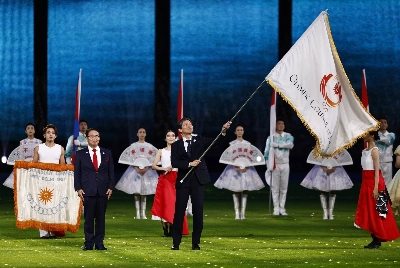 Hideo Nakata, deputy mayor of Nagoya, waves the Olympic Council of Asia flag as Aichi Gov. Hideaki Omura watches during the closing ceremony of the Asian Games in Hangzhou, China, on Oct. 8, 2023. Hideo Nakata, deputy mayor of Nagoya, waves the Olympic Council of Asia flag as Aichi Gov. Hideaki Omura watches during the closing ceremony of the Asian Games in Hangzhou, China, on Oct. 8, 2023.