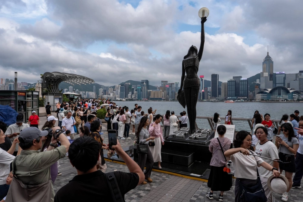 Chinese tour groups visit a waterfront promenade in Hong Kong on May 5. Chinese tour groups visit a waterfront promenade in Hong Kong on May 5.