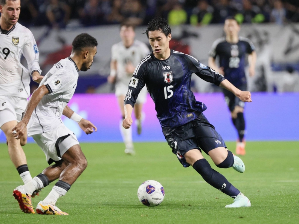Japan's Daichi Kamada (right) dribbles the ball against Indonesia during the World Cup qualifying match at Panasonic Stadium Suita in Osaka Prefecture on Tuesday Japan's Daichi Kamada (right) dribbles the ball against Indonesia during the World Cup qualifying match at Panasonic Stadium Suita in Osaka Prefecture on Tuesday